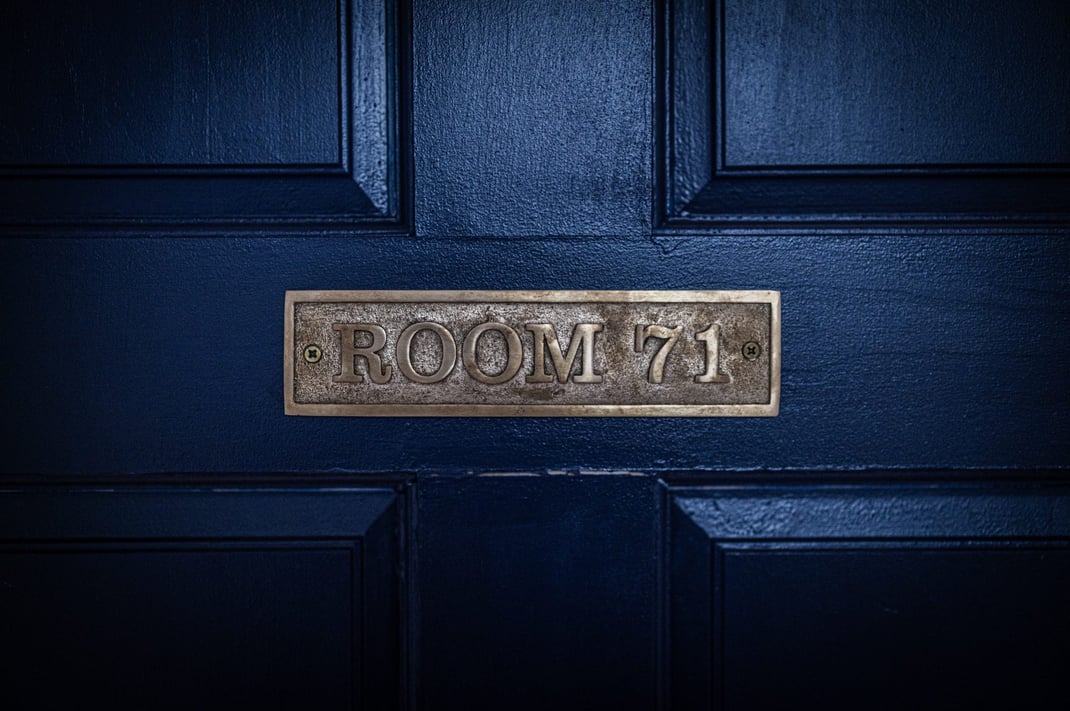 A close-up of a blue door with a plaque that reads "Room 71."