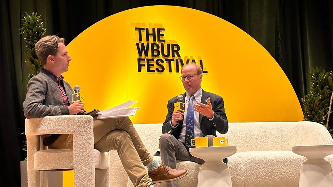 (Left) Host of NPR's Here & Now sits with WHOI President Peter de Menocal in front of a semicircular sign that reads "The WBUR Festival."