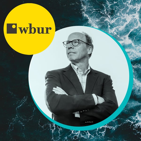 Background, a bird's eye view of the ocean surface with foamy waves washing right to left. Foreground, the WBUR logo in top left, with a picture of WHOI President and Director Peter de Menocal crossing his arms and looking off into the sun.